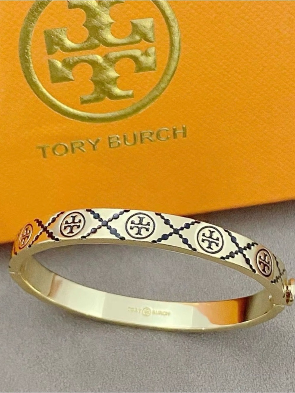 Tory Burch Gold Tone Logo Bangle with Black Enamel Accents